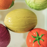Five fruit and vegetable Oli & Carol 100% Natural Rubber Baby Sensory Balls floating in the bath