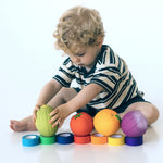 Child colour matching with a variety of Oli & Carol 100% Natural Rubber Baby Sensory Balls