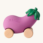 Oli & Carol 100% Natural Rubber Emma the Aubergine Car. A fun purple rubber eggplant car with a green top, and wooden wheels on a cream background