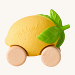 Oli & Carol Lou The Lemon Baby Car. A fun yellow lemon car with a green leafy top, and wooden wheels on a cream background