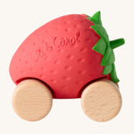 Oli & Carol Sweetie The Strawberry Baby Car. A fun red strawberry car with a green leafy top, and wooden wheels on a cream background