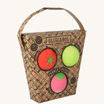 Oli & Carol Veggie Salad Baby Sensory Balls in their basket shaped cardboard packaging, a tomato, cabbage and a radish