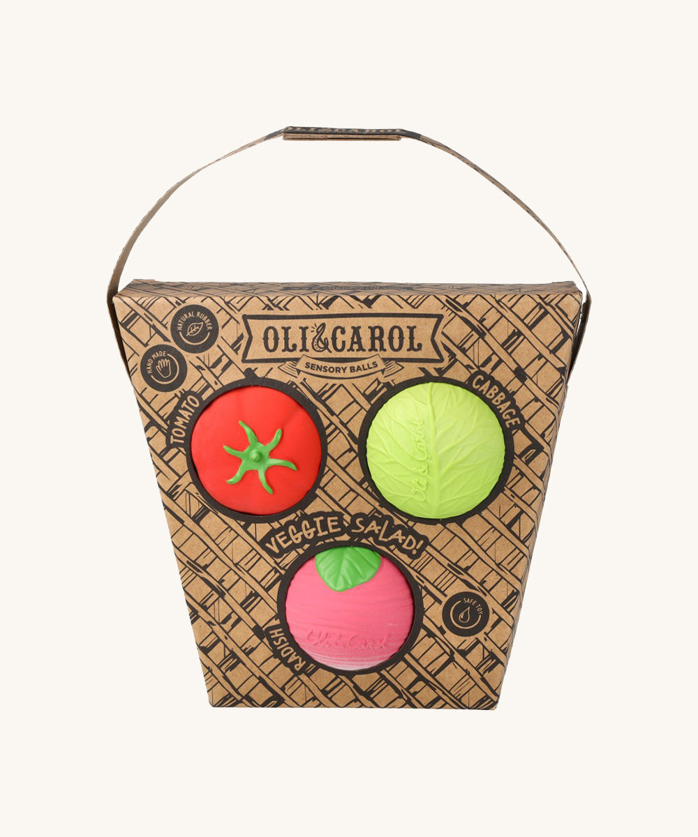 Oli & Carol Veggie Salad Baby Sensory Balls in their basket shaped cardboard packaging, a tomato, cabbage and a radish