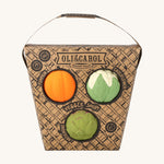 Oli & Carol Vegetable soup Baby Sensory Balls in their basket shaped cardboard packaging, a pumpkin, cauliflower and an artichoke. 