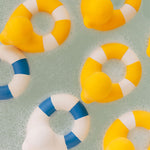 Yellow coloured Oli & Carol Flo The Floatie Ducks in bubbly bath water