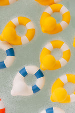 Yellow coloured Oli & Carol Flo The Floatie Ducks in bubbly bath water