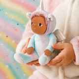 Olli Ella Dinky dinkum doll Uli Unicorn available at Babipur. Close up of soft cuddly doll held by a child with a glittery rainbow background.  