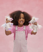 A child playing with the pink and lilac baby unicorns from Olli Ella