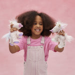 Child playing with both the pink and lilac baby unicorn toys