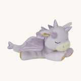 A Olli Ella binky misty dragon doll lying flat. This fluffy light purple dragon has a sleeping face,  features glittery wings, horns and available at Babipur.