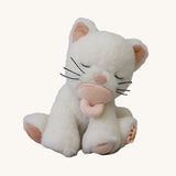 A Olli Ella Koda Kiki kitten doll sitting with the light pink magnetic pacifier in the mouth. This cute fluffy toy doll is available at Babipur