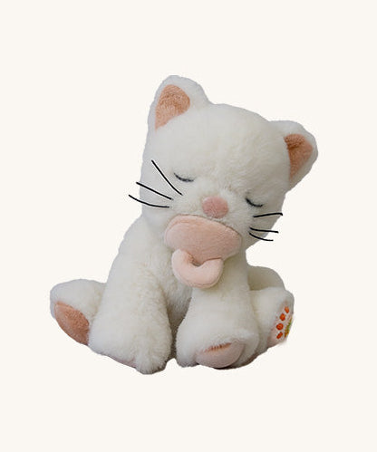 A Olli Ella Koda Kiki kitten doll sitting with the light pink magnetic pacifier in the mouth. This cute fluffy toy doll is available at Babipur
