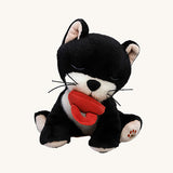 A Olli Ella Kit binky kitten doll sitting with the red magnetic pacifier in the mouth. This cute fluffy toy doll is available at Babipur