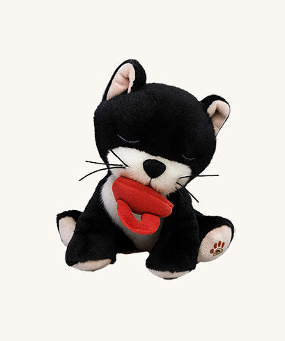 A Olli Ella Kit binky kitten doll sitting with the red magnetic pacifier in the mouth. This cute fluffy toy doll is available at Babipur