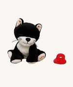 A sitting Olli Ella Kit binky kitten doll available at Babipur. This cute black fluffy kitten doll has light pink paws, whiskers and comes with a red magnetic pacifier.