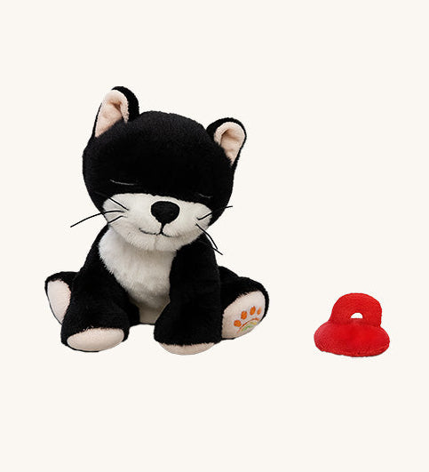 A sitting Olli Ella Kit binky kitten doll available at Babipur. This cute black fluffy kitten doll has light pink paws, whiskers and comes with a red magnetic pacifier.