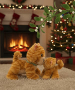 A festive image of a Olli Ella binx cat dinkum doll and koda the binky kitten kissing under a mistletoe. Both of these toy dolls are available at Babipur.