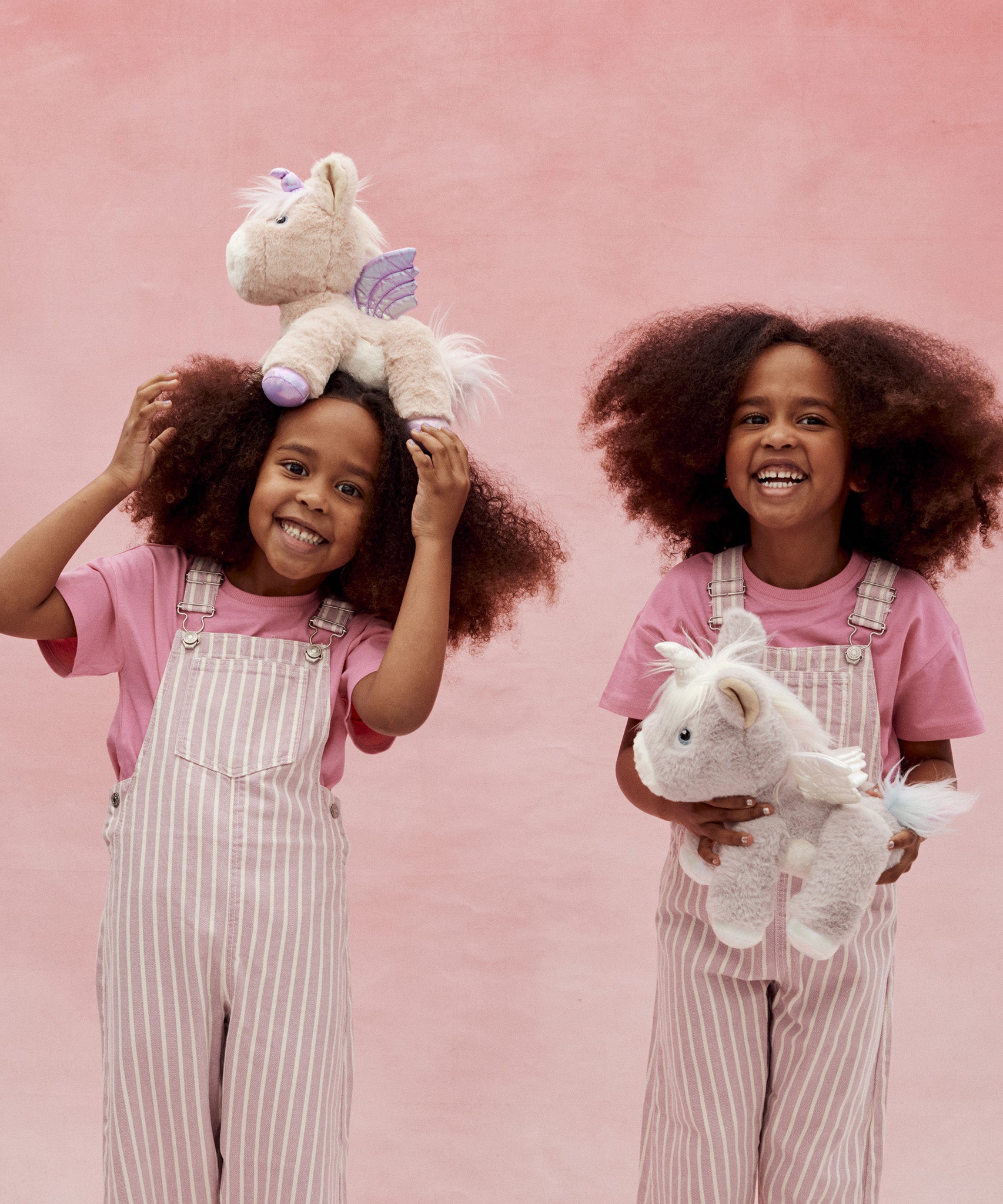 Two children playing with the unicorn toys from Olli Ella