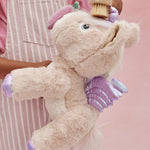 A child brushes the toy unicorn