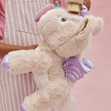 A child brushes the toy unicorn