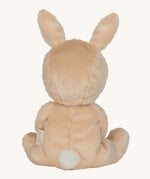 Olli Ella light sand coloured Bubba Bunny Dinky Dinkum Doll in a seated position facing away from the camera. The back of the dolly can be seen with a white fluffy tail on. 
