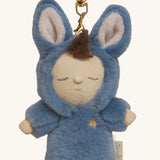 A close up of the Olli Ella bunny twiggy cozy bag charm available at Babipur showing the charm's cute facial features and clip attached to the charm to clip on a backpack