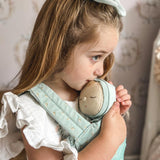 Young girl holding an Olli Ella dozy dinkum moppet ocean dozy dinkum in the ocean print carrier