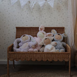 Olli Ella Natural Petal Storie Bench shown with the lid open. There are four Dozy Dinkum bunnies sitting inside. 