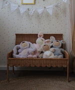 Olli Ella Natural Petal Storie Bench shown with the lid open. There are four Dozy Dinkum bunnies sitting inside. 