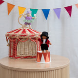 Olli Ella red and white rattan circus basket tent on a wooden surface with 2 circus inspired holdie folk dolls available at Babipur. 