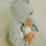 A child wearing a dragon outfit and holding the Olli Ella Ash cozy dinkum doll
