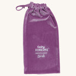 A lilac velvet bag for the fluffy unicorn Olli Ella dozy dinkum doll on a cream background