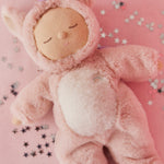 A lifestyle photo of the pink Olli Ella unicorn cosy dinkum doll.