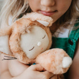 the young girl cuddles the toy.