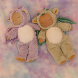 Olli Ella Rory cozy dinkum doll lying next to the Ash cozy dinkum