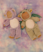 Olli Ella Rory cozy dinkum doll lying next to the Ash cozy dinkum