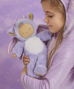 A child holding the Olli Ella Rory cozy dinkum doll 