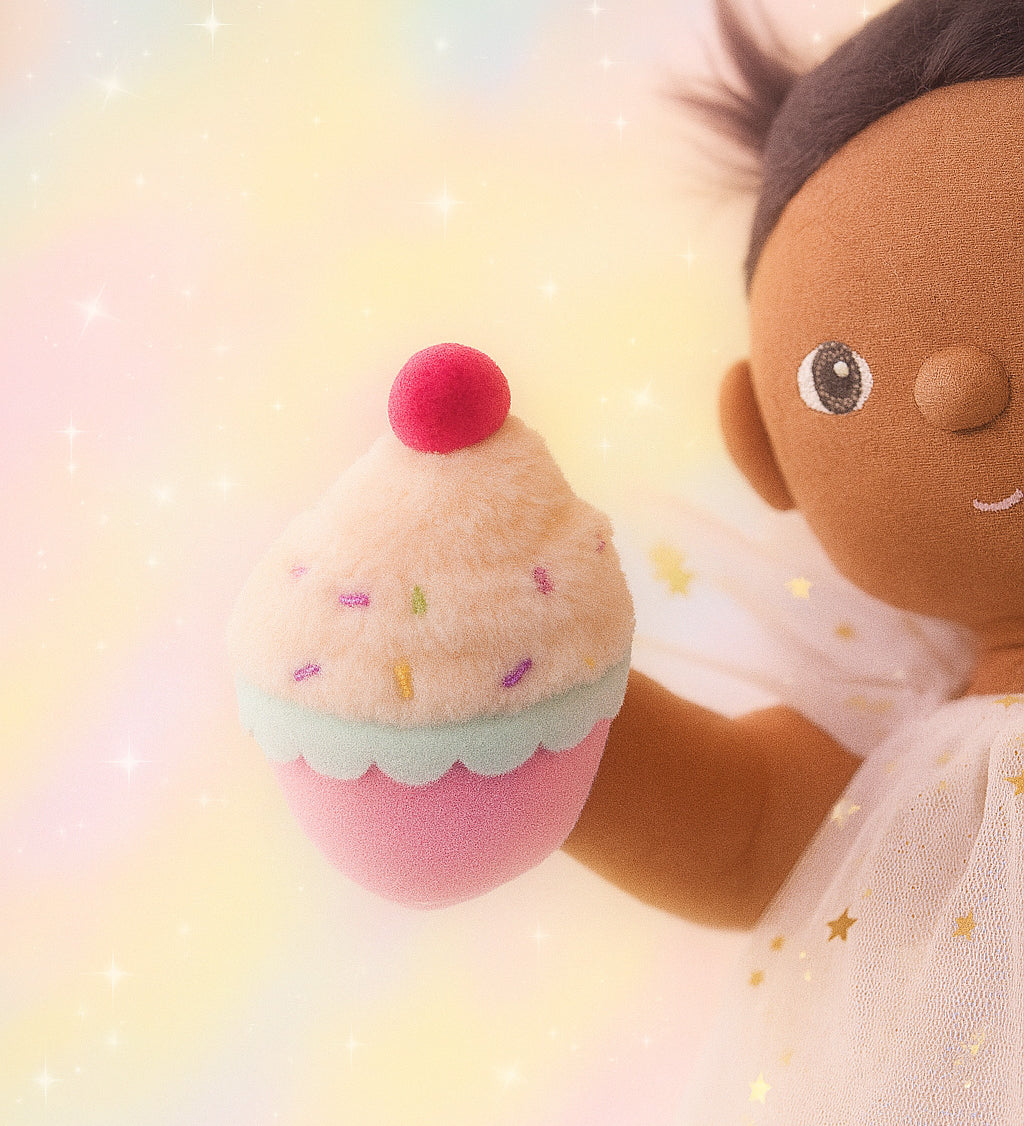 Olli Ella Freya dinkum doll holding the cupcake from the Olli Ella fairy food set.