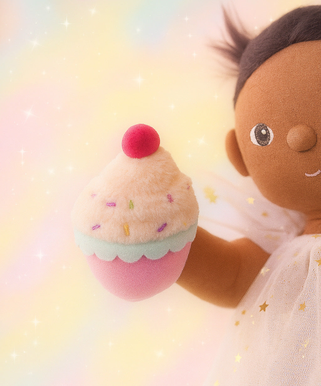 Olli Ella Freya dinkum doll holding the cupcake from the Olli Ella fairy food set.