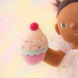 Olli Ella Freya dinkum doll holding the cupcake from the Olli Ella fairy food set.