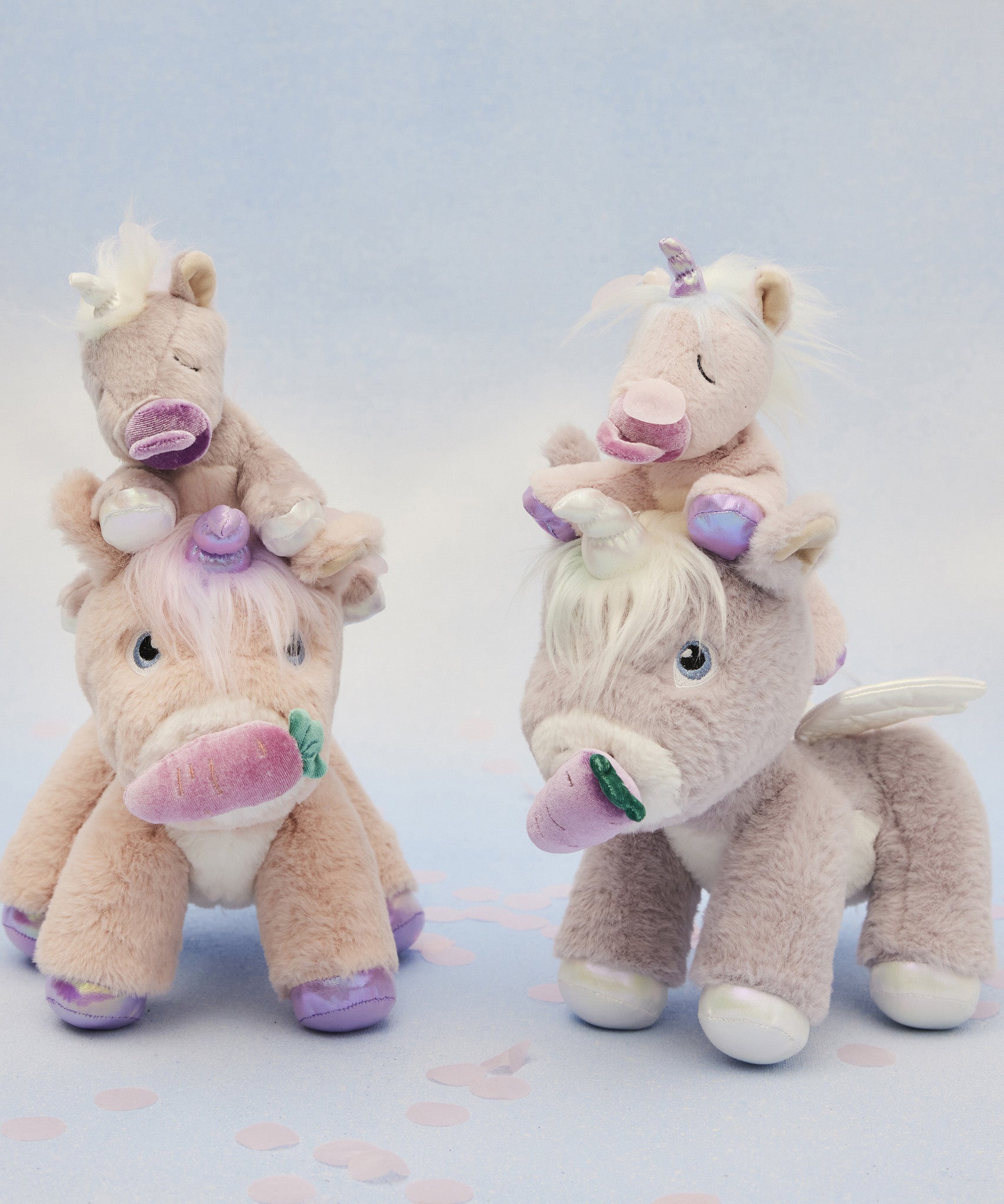 A picture of the dinkum unicorns, with the baby unicorns sat on their heads, with a blue background
