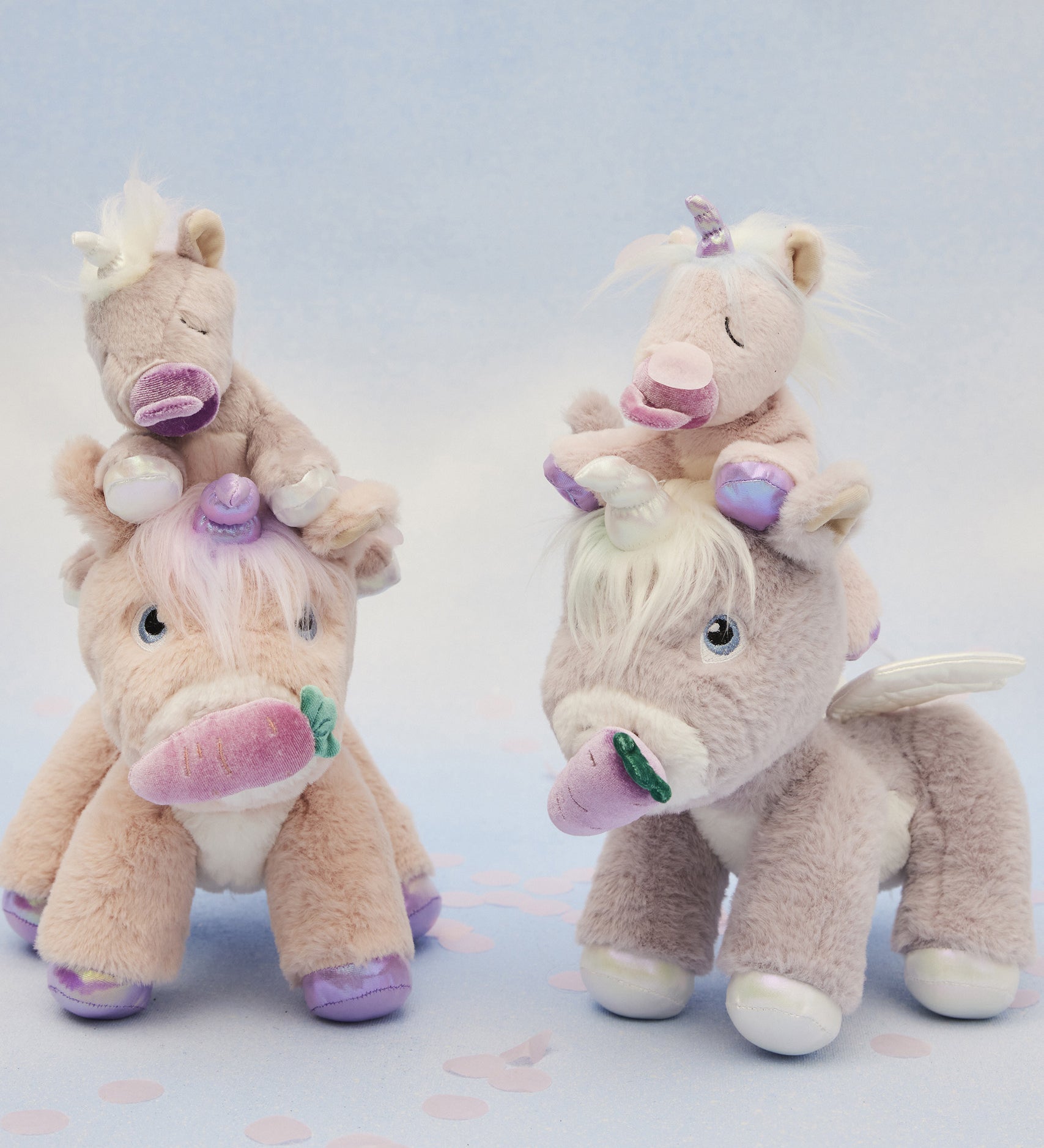 A picture of the dinkum unicorns, with the baby unicorns sat on their heads, with a blue background
