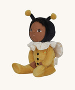 The Olli Ella Dinky Dinkum Doll - Billie Bumblebee - in a yellow onesie with a black hood and antennae, with a white ruffled collar, brown eyes, and buzzy bee wings.