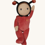 The Olli Ella Dinky Dinkum Doll - Lola Ladybug - in a red onesie with a black hood, brown hair and eyes, spotty ladybird wings, and antennae.