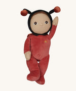 The Olli Ella Dinky Dinkum Doll - Lola Ladybug - in a red onesie with a black hood, brown hair and eyes, spotty ladybird wings, and antennae.
