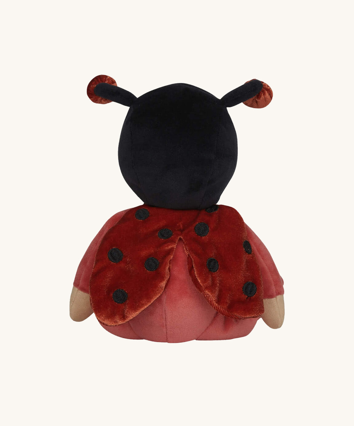 The back of the Olli Ella Dinky Dinkum Doll - Lola Ladybug - in a red onesie with a black hood, with spotty ladybird wings and antennae.