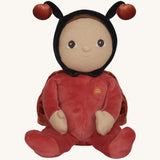 The Olli Ella Dinky Dinkum Doll - Lola Ladybug - in a red onesie with a black hood, brown hair and eyes, spotty ladybird wings, and antennae.