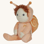 The Olli Ella Dinky Dinkum Doll - Scottie Snail - in a soft light orange onesie with curly red hair, a snail shell on his back, and antennae.