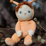 The Olli Ella Dinky Dinkum Doll - Scottie Snail - in a soft light orange onesie with curly red hair, a snail shell on his back, and antennae.