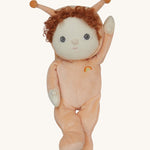 The Olli Ella Dinky Dinkum Doll - Scottie Snail - in a soft light orange onesie with curly red hair, a snail shell on his back, and antennae.